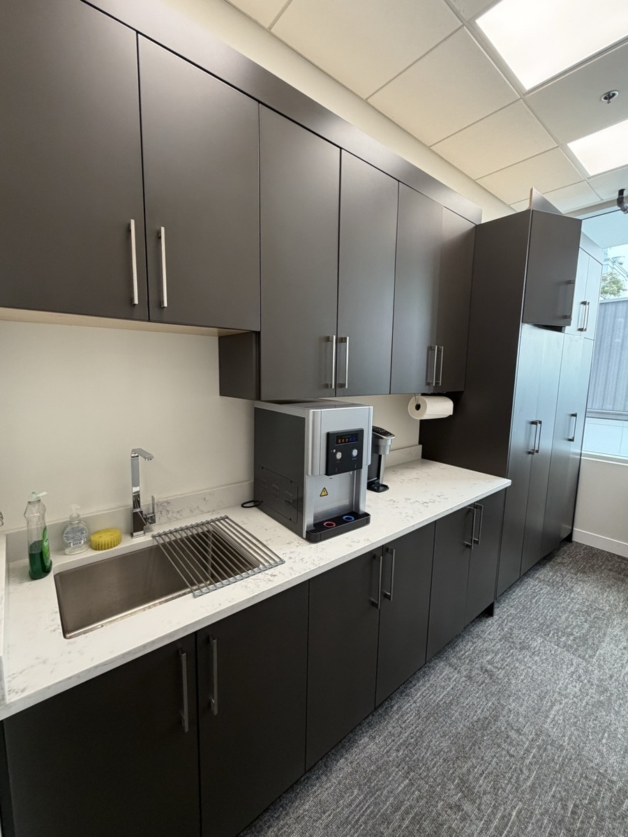 Kitchen lounge counter with coffee machine and cabinetry